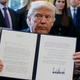 President Donald Trump shows off his signature on an executive order about the Dakota Access pipeline. (Image: AP/Evan Vucci)
